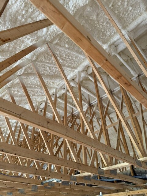 Engineered roof trusses with spray foam insulation on a new build in Wichita Kansas