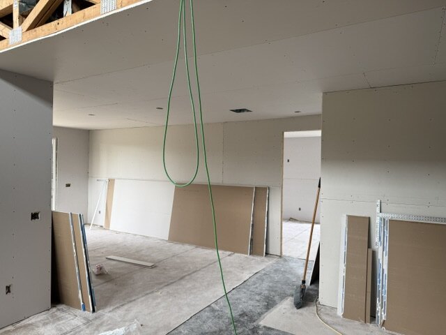 Open concept living area drywall hanging on a new home build in Wichita Kansas